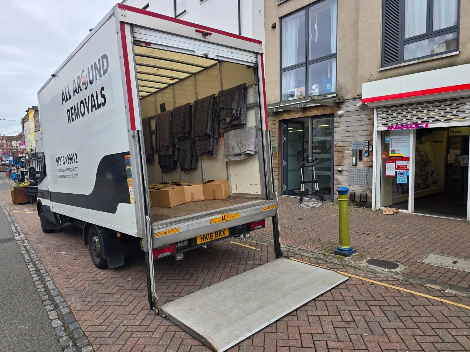 All Around Removals Luton van with its tail lift down on a high street