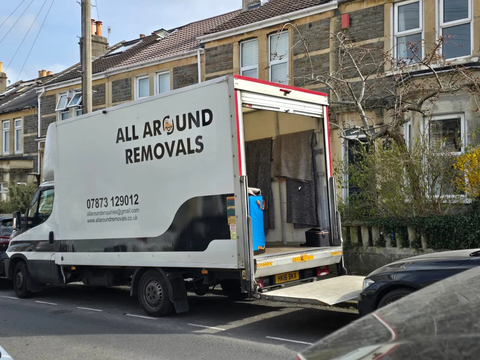 All Around Removals Luton van with doors open outside a terraced house