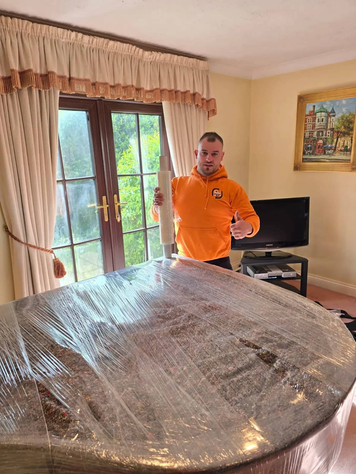 All Around Removals mover with a table protected in stretch wrap
